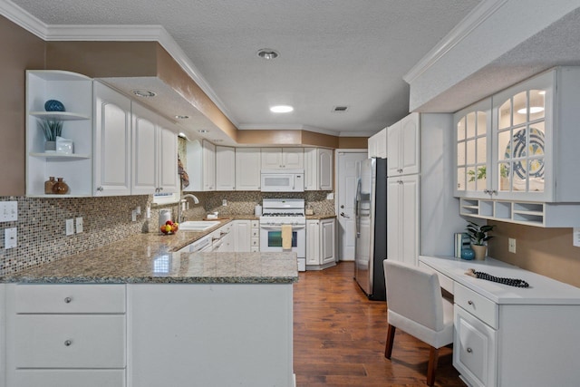 kitchen with white appliances, white cabinetry, dark hardwood / wood-style floors, tasteful backsplash, and kitchen peninsula