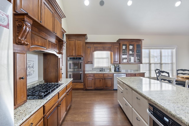 kitchen featuring light stone counters, a healthy amount of sunlight, and stainless steel appliances