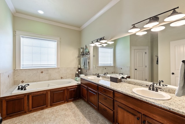 bathroom with crown molding, vanity, and a bathtub