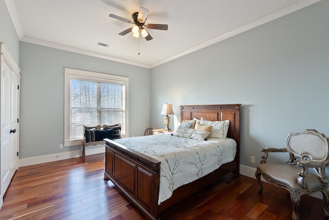 bedroom featuring dark wood-type flooring, ceiling fan, and ornamental molding