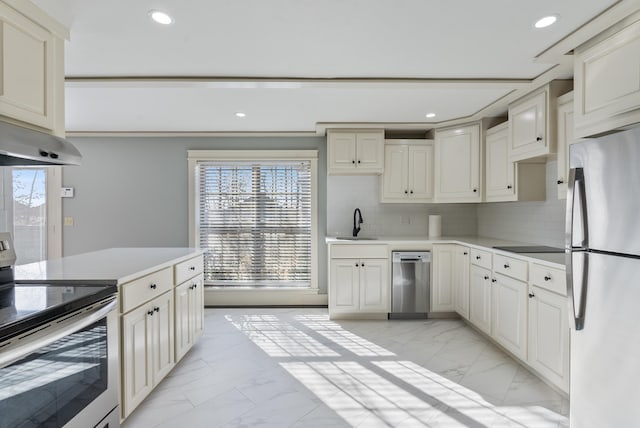 kitchen featuring stainless steel appliances, sink, and decorative backsplash