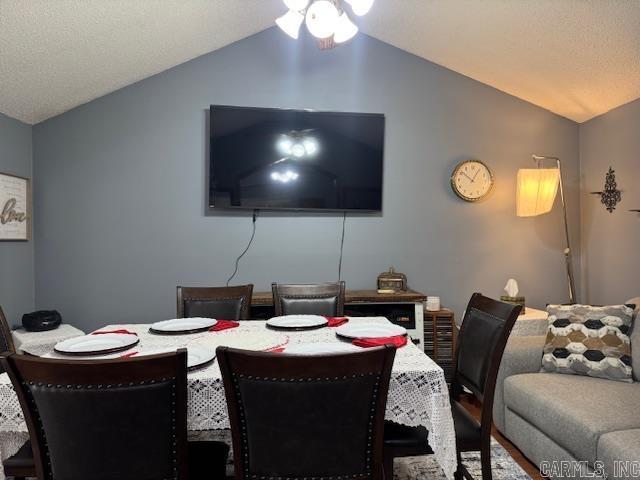 dining area with vaulted ceiling