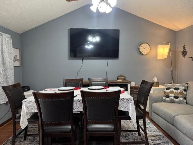 dining area with lofted ceiling, hardwood / wood-style floors, and ceiling fan