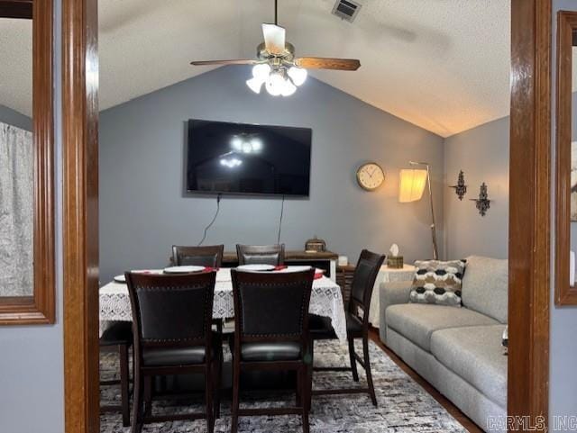 dining area with ceiling fan and lofted ceiling