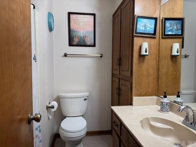 bathroom with vanity, toilet, and tile patterned flooring