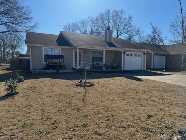 ranch-style house featuring a garage, a front yard, and covered porch