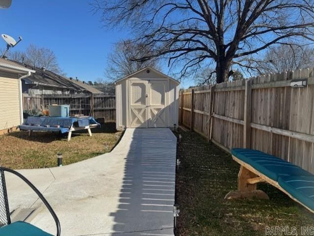 view of yard featuring a pool and a storage unit