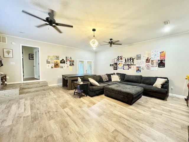 living room featuring french doors, ceiling fan, ornamental molding, and light hardwood / wood-style flooring