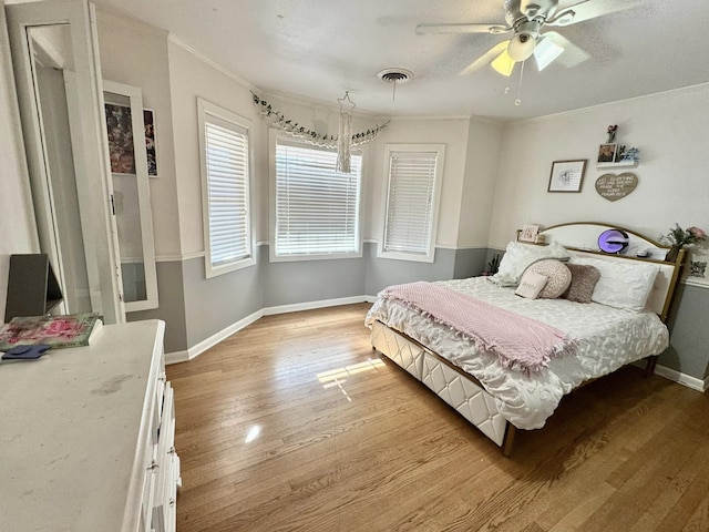 bedroom featuring crown molding, ceiling fan, and light hardwood / wood-style floors