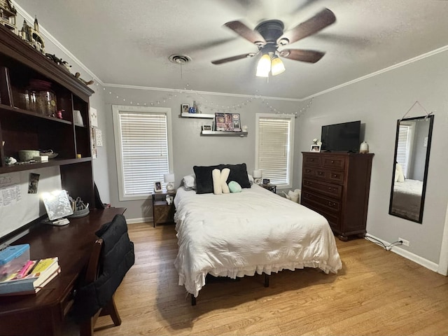 bedroom featuring crown molding, ceiling fan, light hardwood / wood-style flooring, and a textured ceiling