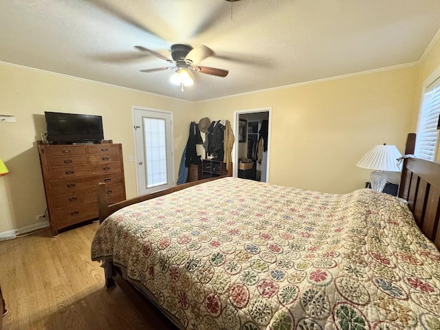 bedroom featuring crown molding, ceiling fan, a spacious closet, and a closet