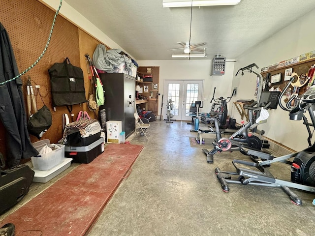 exercise room featuring french doors and a textured ceiling