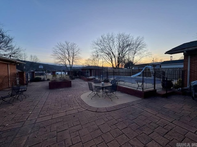 view of patio terrace at dusk