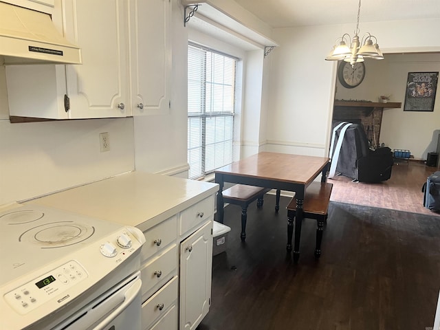 kitchen with pendant lighting, dark wood-type flooring, white cabinetry, stainless steel electric range oven, and custom exhaust hood