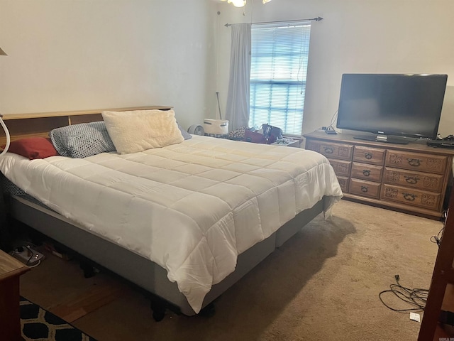 bedroom featuring light carpet