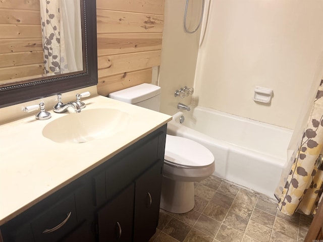 full bathroom featuring shower / bath combo, vanity, wooden walls, and toilet