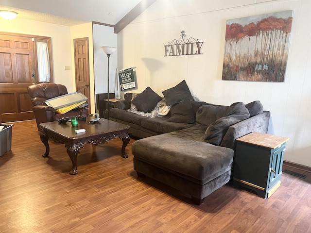 living room featuring hardwood / wood-style flooring and beam ceiling