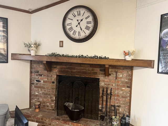 interior details with a brick fireplace and crown molding