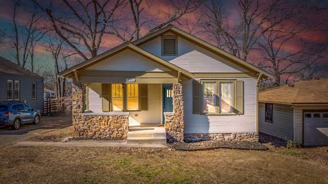 bungalow-style home with a garage and a porch