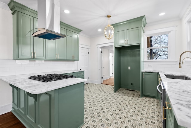 kitchen featuring light stone countertops, green cabinets, sink, and island range hood