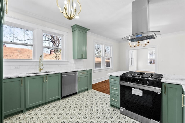 kitchen featuring appliances with stainless steel finishes, sink, island exhaust hood, ornamental molding, and green cabinets