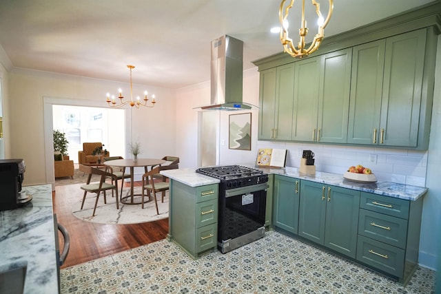 kitchen featuring island range hood, decorative light fixtures, a chandelier, range with gas stovetop, and green cabinets