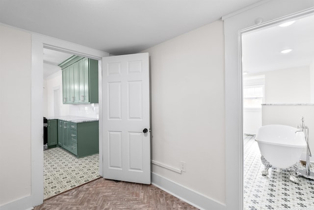 bathroom featuring a bathing tub, parquet floors, vanity, and backsplash