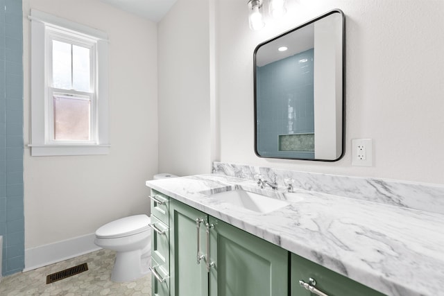 bathroom featuring vanity and toilet