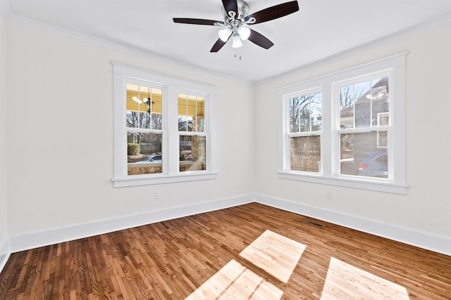 spare room with wood-type flooring, ornamental molding, and ceiling fan