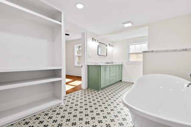 bathroom with vanity and a washtub