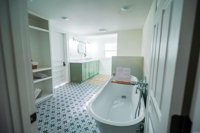 bathroom featuring vanity and a tub