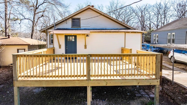 rear view of house with a wooden deck