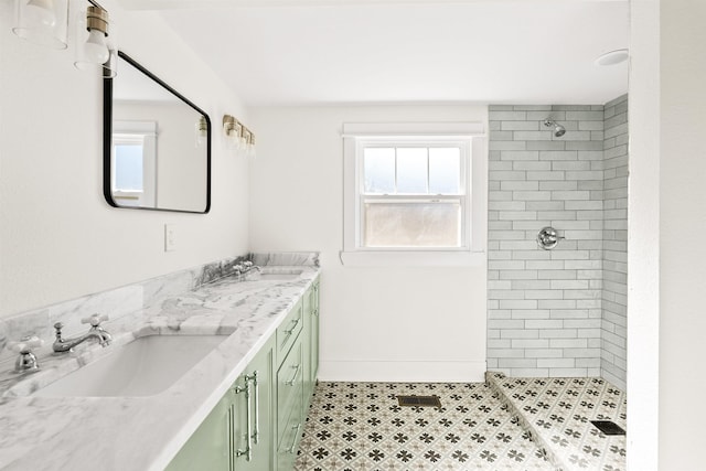 bathroom with vanity and a tile shower