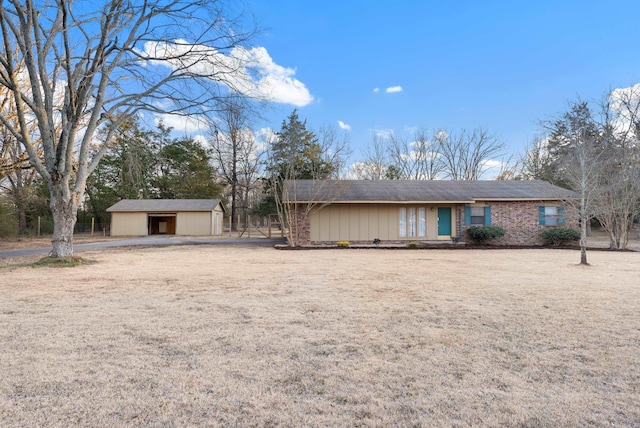 single story home with a garage and an outdoor structure