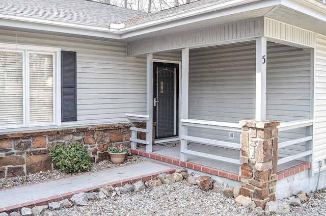 view of exterior entry with covered porch