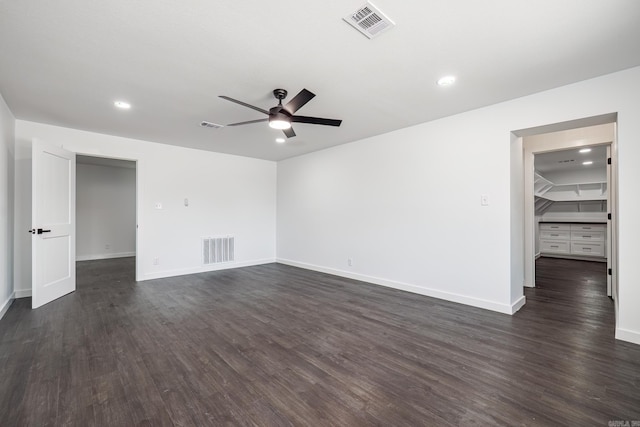 spare room with ceiling fan and dark hardwood / wood-style flooring