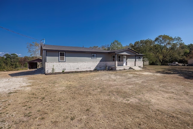 back of property featuring a porch and a lawn