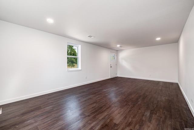 spare room with dark wood-type flooring