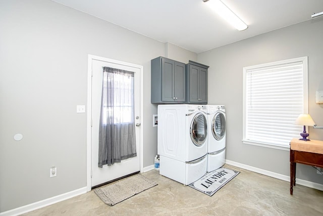 laundry room with cabinets and washer and dryer