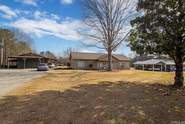 single story home featuring a front lawn and a carport