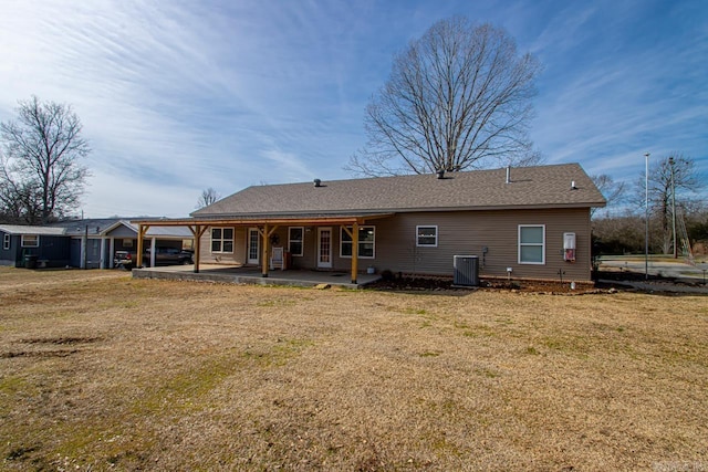 back of property featuring central AC, a lawn, and a patio area