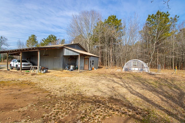 view of outbuilding featuring a carport