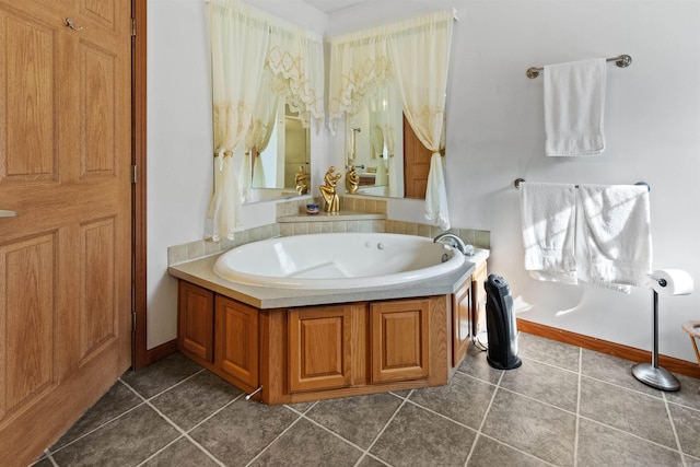 bathroom with a washtub and tile patterned floors