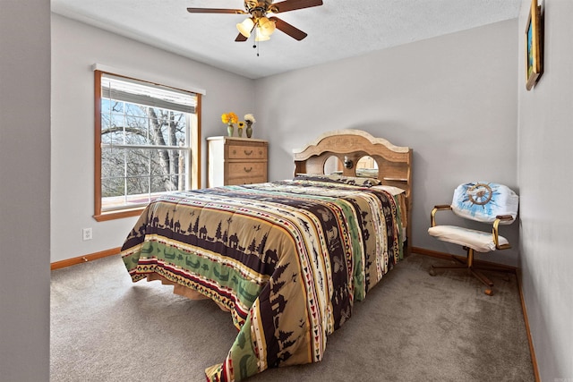 bedroom with ceiling fan, carpet flooring, and a textured ceiling