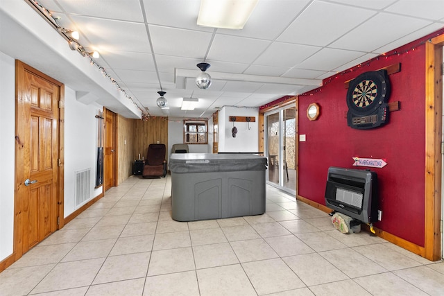 kitchen with heating unit, light tile patterned floors, and a drop ceiling