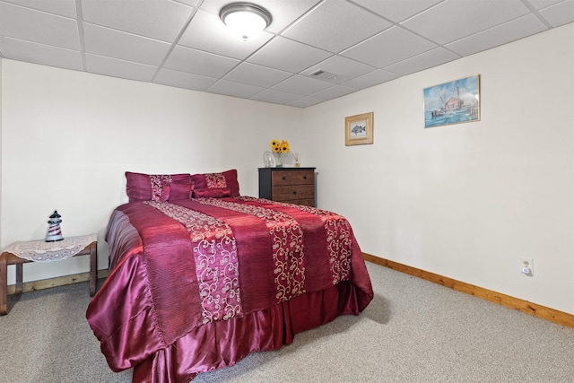 carpeted bedroom with a drop ceiling