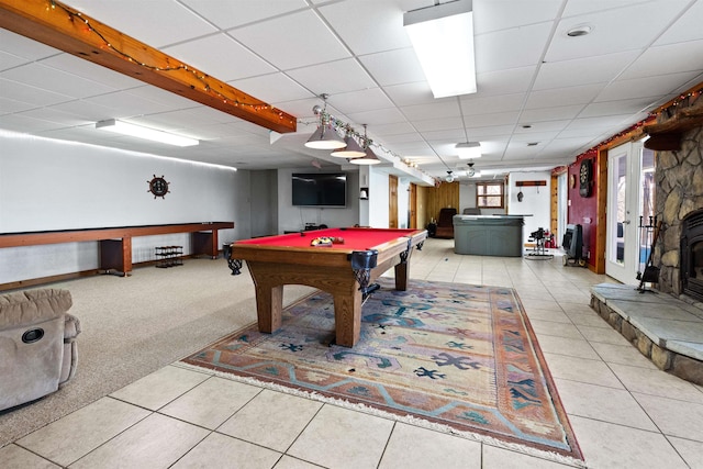 playroom with billiards, light colored carpet, and a wood stove