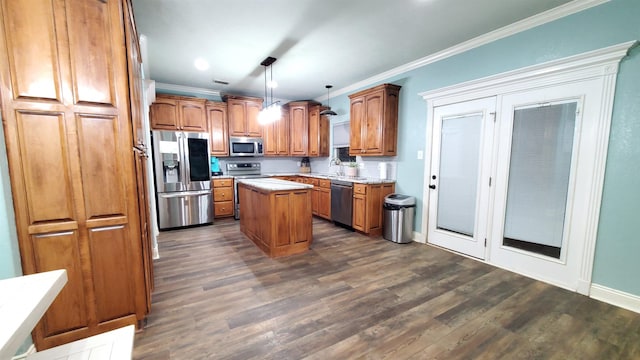 kitchen with crown molding, a center island, hanging light fixtures, stainless steel appliances, and decorative backsplash