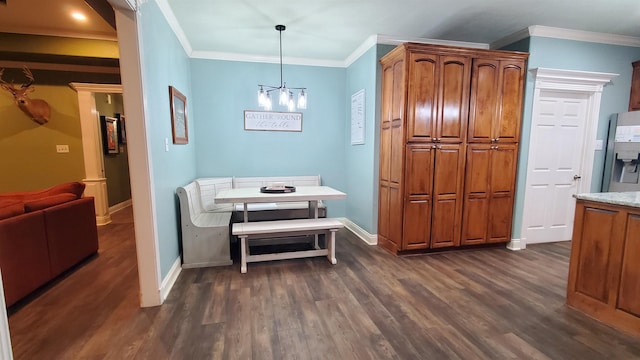 dining space featuring breakfast area, dark wood-type flooring, ornamental molding, and a chandelier