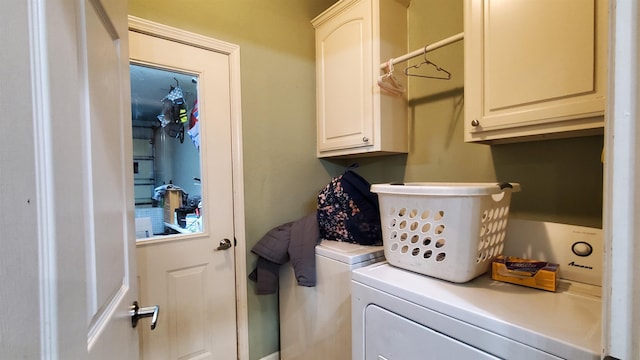 washroom with cabinets and washer and clothes dryer